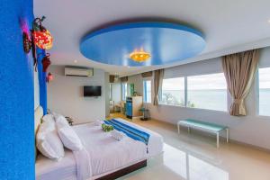 a bedroom with a large bed with a blue ceiling at Pearl By The Sea Resort in Prachuap Khiri Khan +162 photos