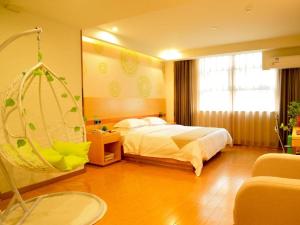 a bedroom with a bed and a swing at GreenTree Inn Yangzhou East Passenger Station He Garden in Yangzhou +90 photos