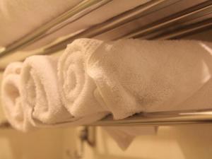a white towel on a towel rack in a bathroom at Midland Hotel in Phnom Penh +167 photos