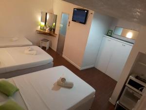 a small room with two beds and a tv at House of Big Brother in Puerto Princesa City +106 photos