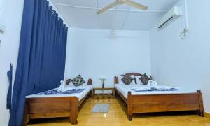 Postel nebo postele na pokoji v ubytování Gokanna Pearl Guest & Hostels