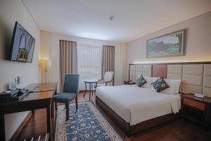 TV a/nebo společenská místnost v ubytování Grand Qin Hotel Syariah