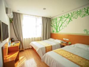 a hotel room with two beds and a window at Vatica Tianjin Jinghai Bus Station Home World Plaza Hotel in Tianjin +219 photos