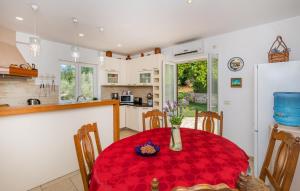 a kitchen with a table with a red table cloth at Villa Olive by Villas Guide in Imotica