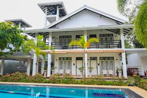 an exterior view of a house with a swimming pool at WetLand Resort in Negombo