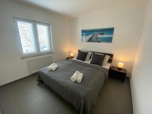 a bedroom with a bed with two towels on it at Apartments Katharina in Batalaži