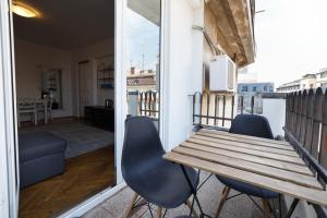 a balcony with a wooden table and two chairs at Calea Victoriei View in Bucharest