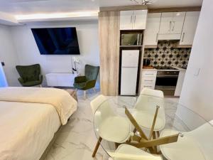 a bedroom with a bed and a table and chairs at 34 On The Den in Stellenbosch