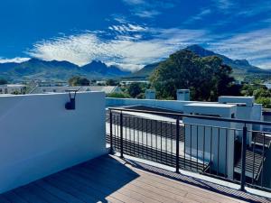 a balcony with a view of the mountains at 34 On The Den in Stellenbosch