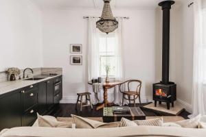 a kitchen with a stove and a table at Montville Estate - Luxury Hinterland Home & Pool in Montville