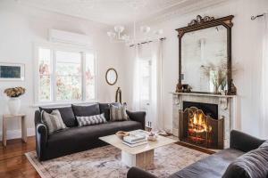 a living room with a couch and a fireplace at Luxe Hinterland Stay, Eastnor at Montville Estate in Montville