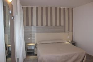Postel nebo postele na pokoji v ubytování Hotel Miralago