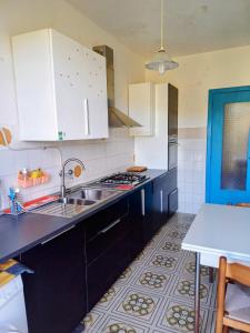 a kitchen with white cabinets and a sink at Tra Mare e Collina c'è Belmare in Montecorice +16 photos