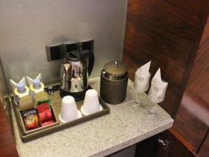 a counter with a coffee pot and a tray of food at Inner Mongolia Hotel Forbidden City in Beijing