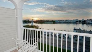 a white chair on a balcony with a view of the water at Disney's Yacht Club Resort in Orlando