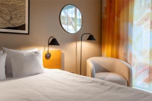 A bed or beds in a room at Hyatt Place Gothenburg Central