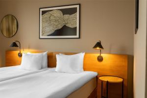 A bed or beds in a room at Hyatt Place Gothenburg Central