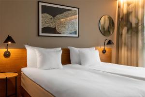 A bed or beds in a room at Hyatt Place Gothenburg Central