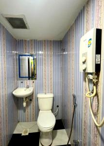 a bathroom with a toilet and a sink at Hartamas Business Hotel in Kuala Lumpur