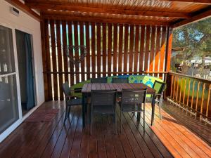 a wooden deck with a table and chairs on it at Mobile home sunshine in Drage