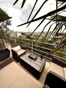 a balcony with a table and a view of a city at Luxury Flat With Terrace & Eiffel Tower View in Paris