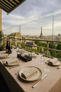 a table with wine glasses and a view of the eiffel tower at Luxury Flat With Terrace & Eiffel Tower View in Paris