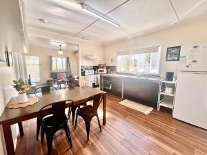 a kitchen and dining room with a table and chairs at Denham Cottage - Quart Pot Creek in Stanthorpe