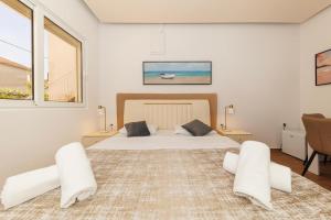 a bedroom with a large bed with two chairs at Premium Rooms Prince in Zadar