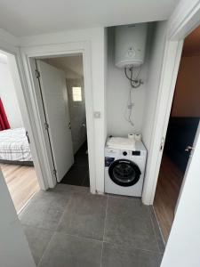 a washer and dryer in a small room with a bathroom at Cyprus Apart Hotel in Famagusta +27 photos
