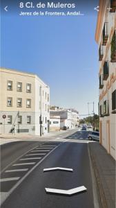 an empty street with a white arrow on the road at Altos de Jerez & Parking Privado in Jerez de la Frontera