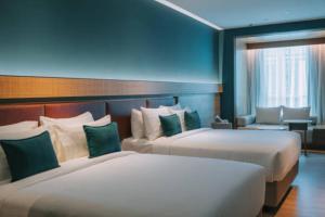 Postel nebo postele na pokoji v ubytování EL DE Olive Aero Suites Near Delhi Airport