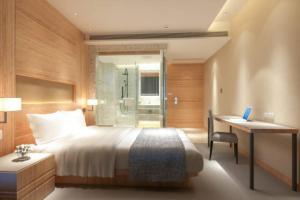 Postel nebo postele na pokoji v ubytování EL DE Olive Aero Suites Near Delhi Airport + 24 fotografií