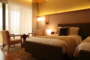 Postel nebo postele na pokoji v ubytování EL DE Olive Aero Suites Near Delhi Airport