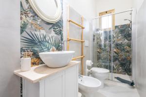 a bathroom with a sink and a toilet and a shower at Gerani Rossi Appartamento in Villa San Pietro
