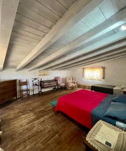 a bedroom with a large bed with a red blanket at Villa Taormina Sicily in Furci Siculo