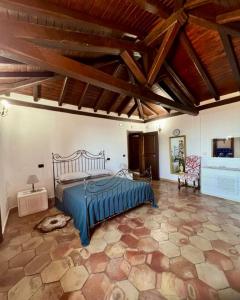 a bedroom with a bed in a room with wooden ceilings at Villa Taormina Sicily in Furci Siculo