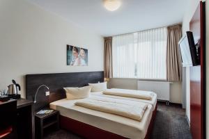 Postel nebo postele na pokoji v ubytování Hotel Bloemfontein