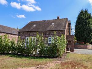a brick house with bushes in front of it at Egerton Cottage in Crewe