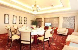 a dining room with a white table and chairs at Asia Pacific Garden Hotel - Beijing in Beijing