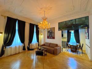 a living room with a couch and a dining room at 7th HEAVEN Vienna Center Apartments in Vienna