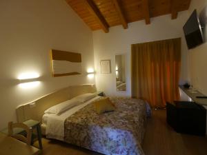 a bedroom with a bed and a desk and a television at Bosco Romagno in Cividale del Friuli +45 photos