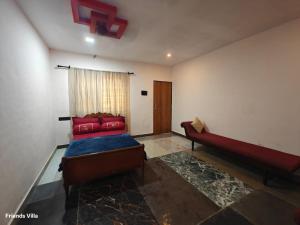 a room with a bed and a couch and a window at Paradise Farm Alibaug in Kashid +51 photos