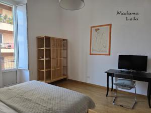 a bedroom with a bed and a desk with a computer at Madama in Bari