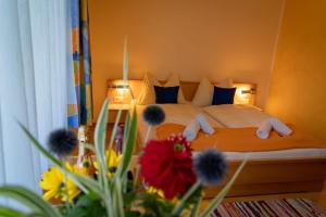 a bedroom with a bed with flowers in the foreground at Familienpension Gletscherblick in Heiligenblut