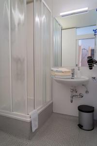 a bathroom with a shower and a sink at Familienpension Gletscherblick in Heiligenblut +52 photos