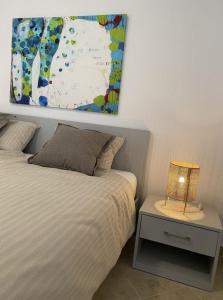 a bedroom with a bed and a table with a lamp at Alto Mare Apartments in Selce