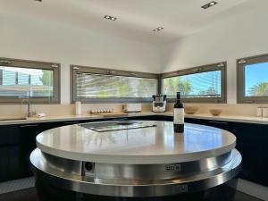a kitchen with a table with a bottle of wine at Villa Deluxe - Jardin del Mar y Cielo in Tacoronte