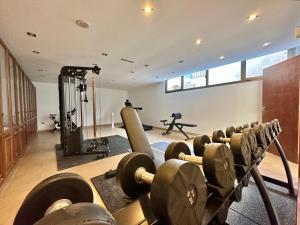 a gym with rows of dumbbells in a room at Villa Deluxe - Jardin del Mar y Cielo in Tacoronte