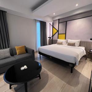 Postel nebo postele na pokoji v ubytování Arosa Hotel Jakarta