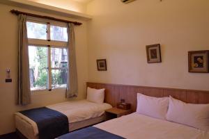 Llit o llits en una habitació de Meinong Yun Shanju Homestay
